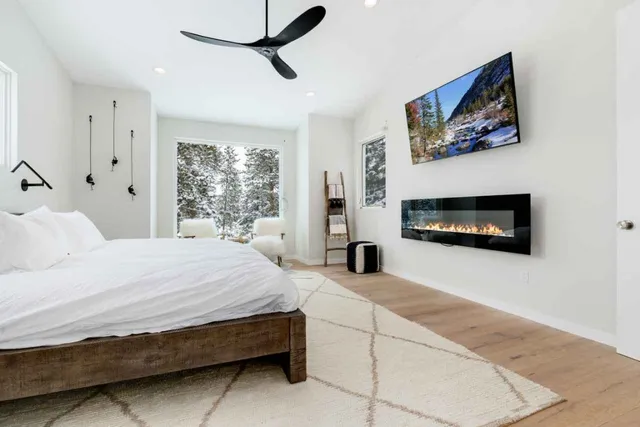 a bedroom with a bed and a flat screen tv