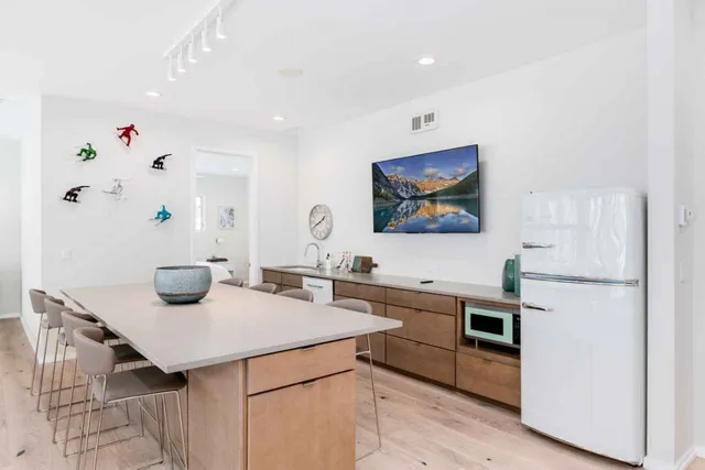 a kitchen with a sink a stove and chairs