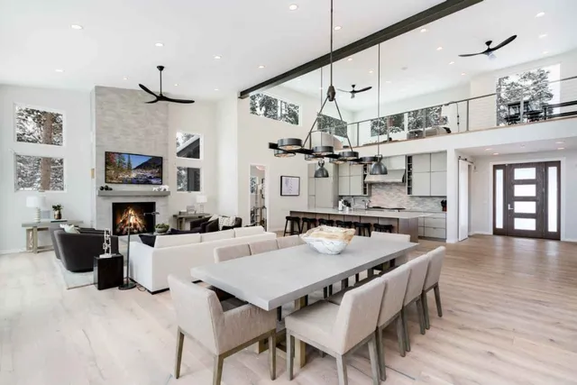 a dinning table and chairs in a room with kitchen view