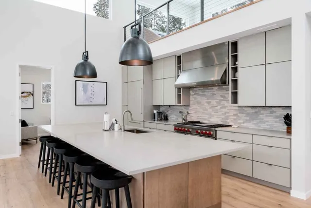 a kitchen with stainless steel appliances a sink and cabinets