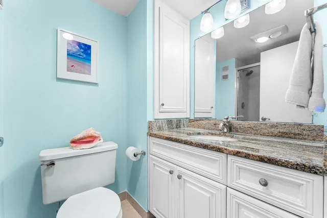 a bathroom with a glass shower door