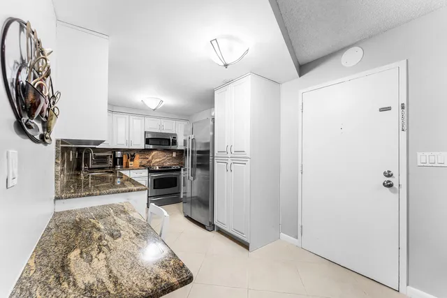 a kitchen with stainless steel appliances granite countertop a stove and a sink