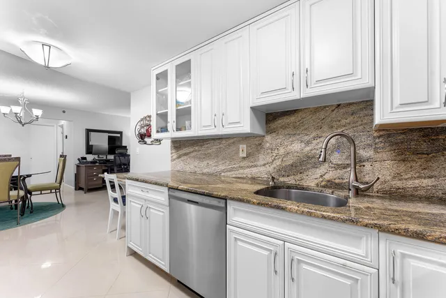 a living room with fireplace furniture and a chandelier
