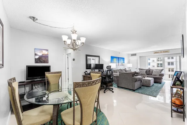 a view of a dining room with furniture and chandelier