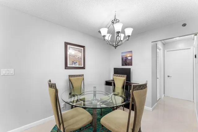 a dining room with furniture and chandelier