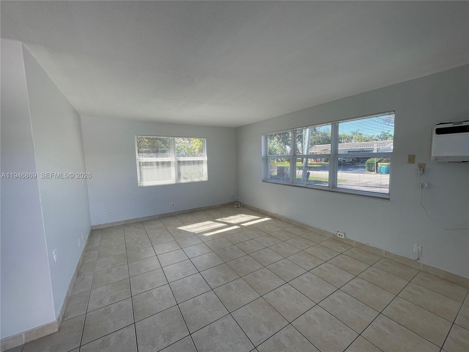 5550 Northeast 20th Terrace, Unit 3 Fort Lauderdale, FL 33308 - Photo 2 of 14 an empty room with windows