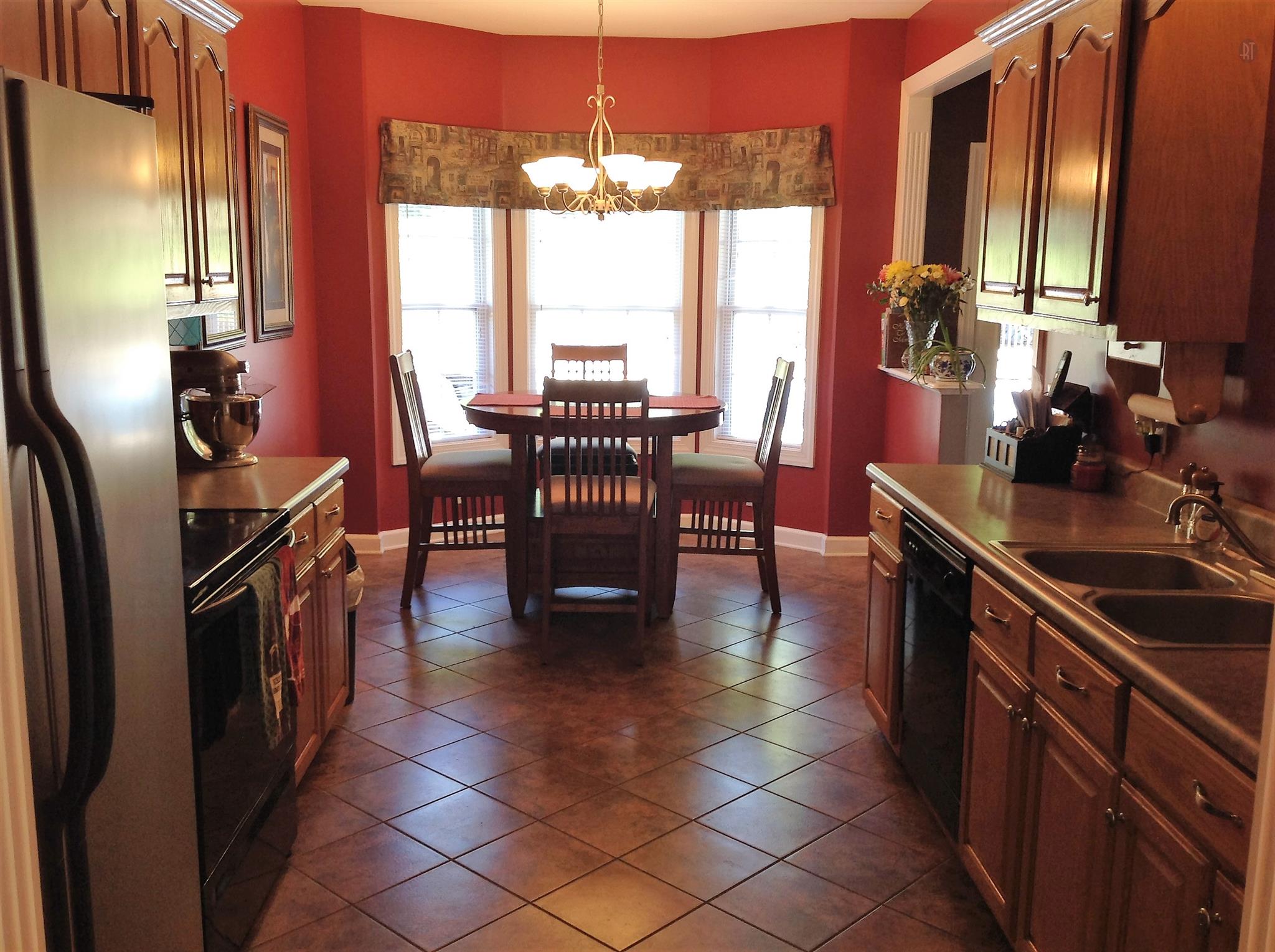 227 Ridgewater Way Mount Juliet, TN 37122 - Photo 7 of 18 a kitchen with stainless steel appliances granite countertop a stove top oven a sink dishwasher a dining table and chairs with wooden floor
