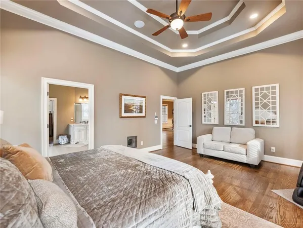 a large white kitchen with granite countertop a sink white cabinets and a window