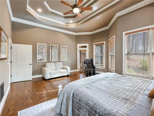 a spacious bathroom with a double vanity sink a mirror a bathtub and a window