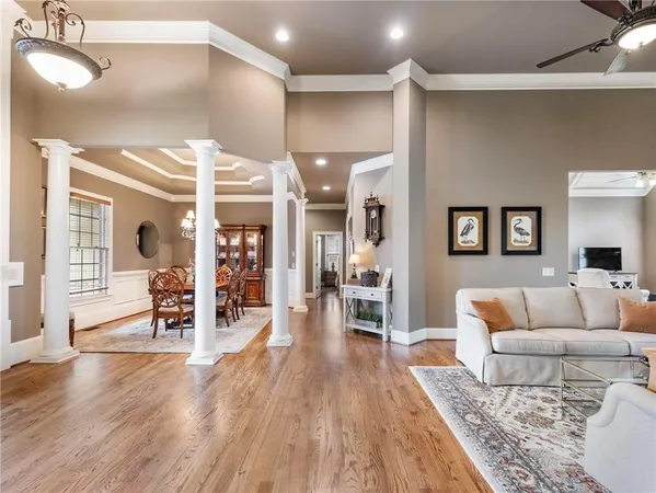 a view of a hallway with wooden floor and staircase