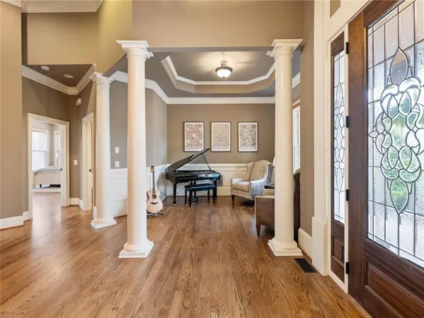 a living room with furniture a piano and a window
