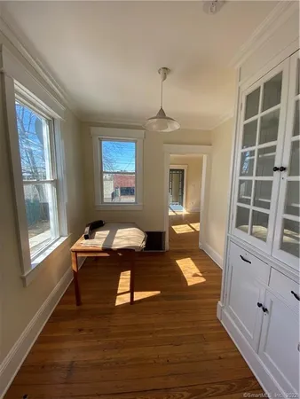 a living room with furniture window and wooden floor