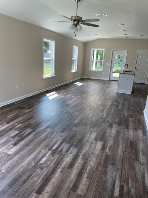 952 Mapoles Street Crestview, FL 32536 - Photo 6 of 23 an empty room with wooden floor and windows