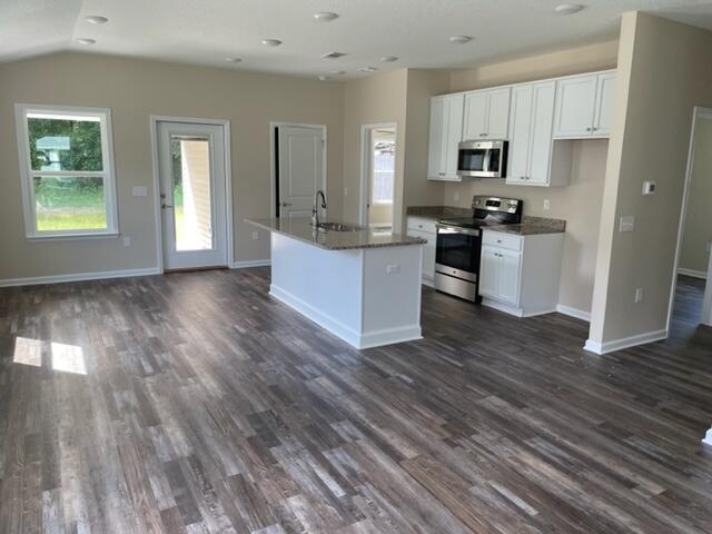 952 Mapoles Street Crestview, FL 32536 - Photo 7 of 23 a kitchen with wooden floors and white appliances