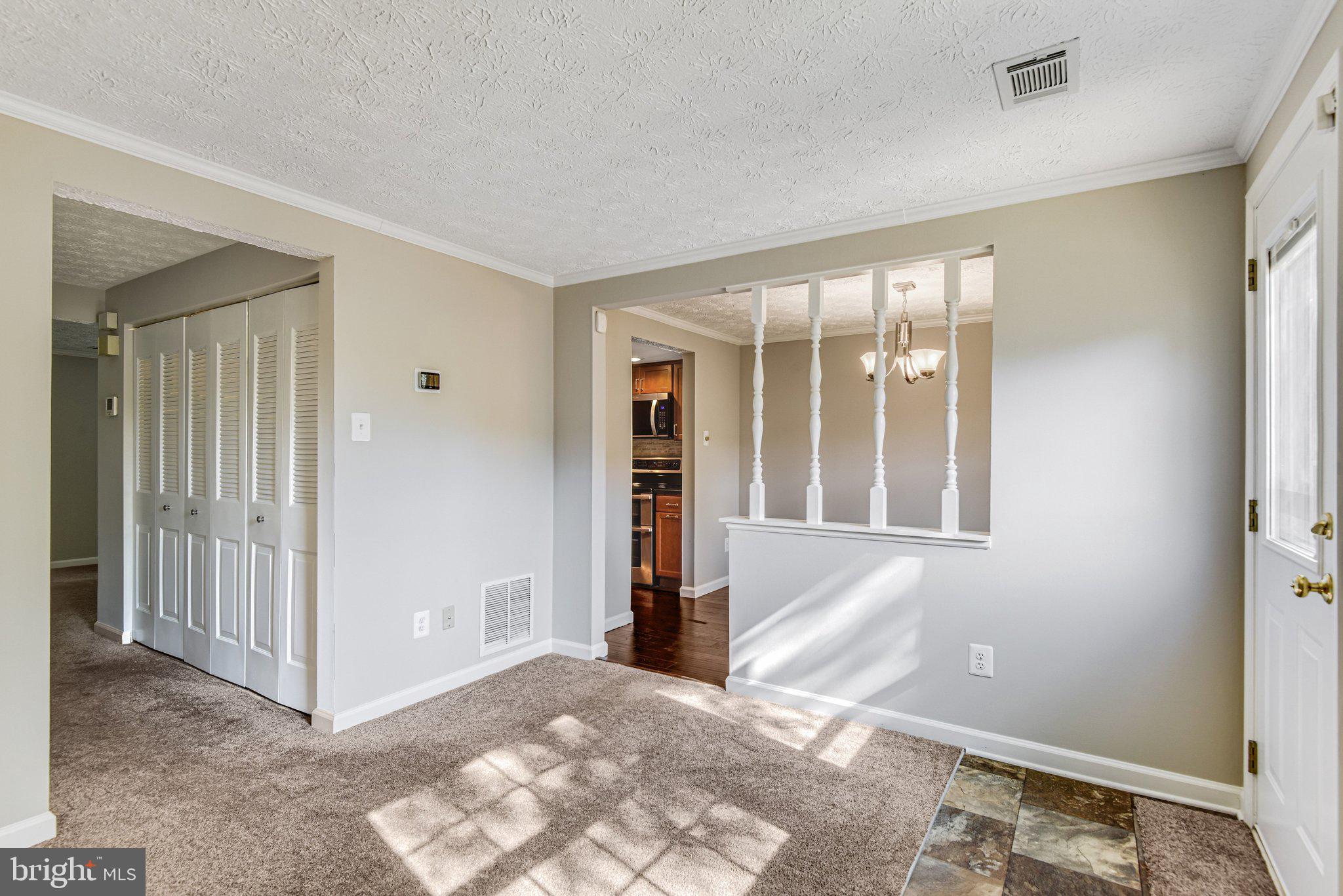 8339 Bark Tree Court Springfield, VA 22153 - Photo 11 of 23 a view of a big room with windows and entryway