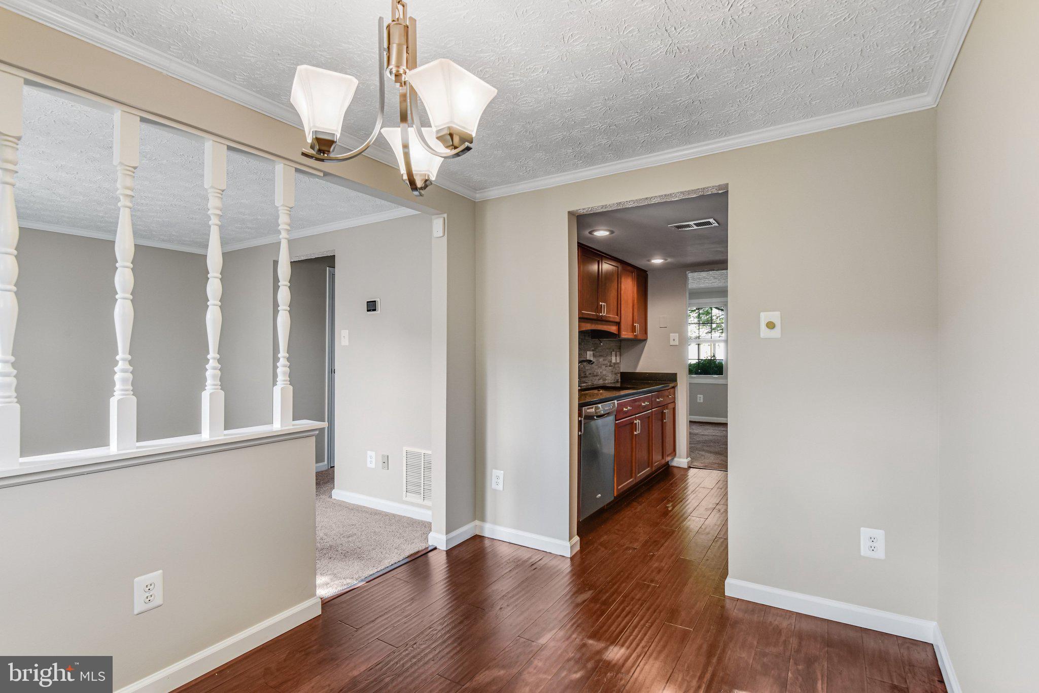 8339 Bark Tree Court Springfield, VA 22153 - Photo 9 of 23 a view of a kitchen with a stove wooden floor and a kitchen