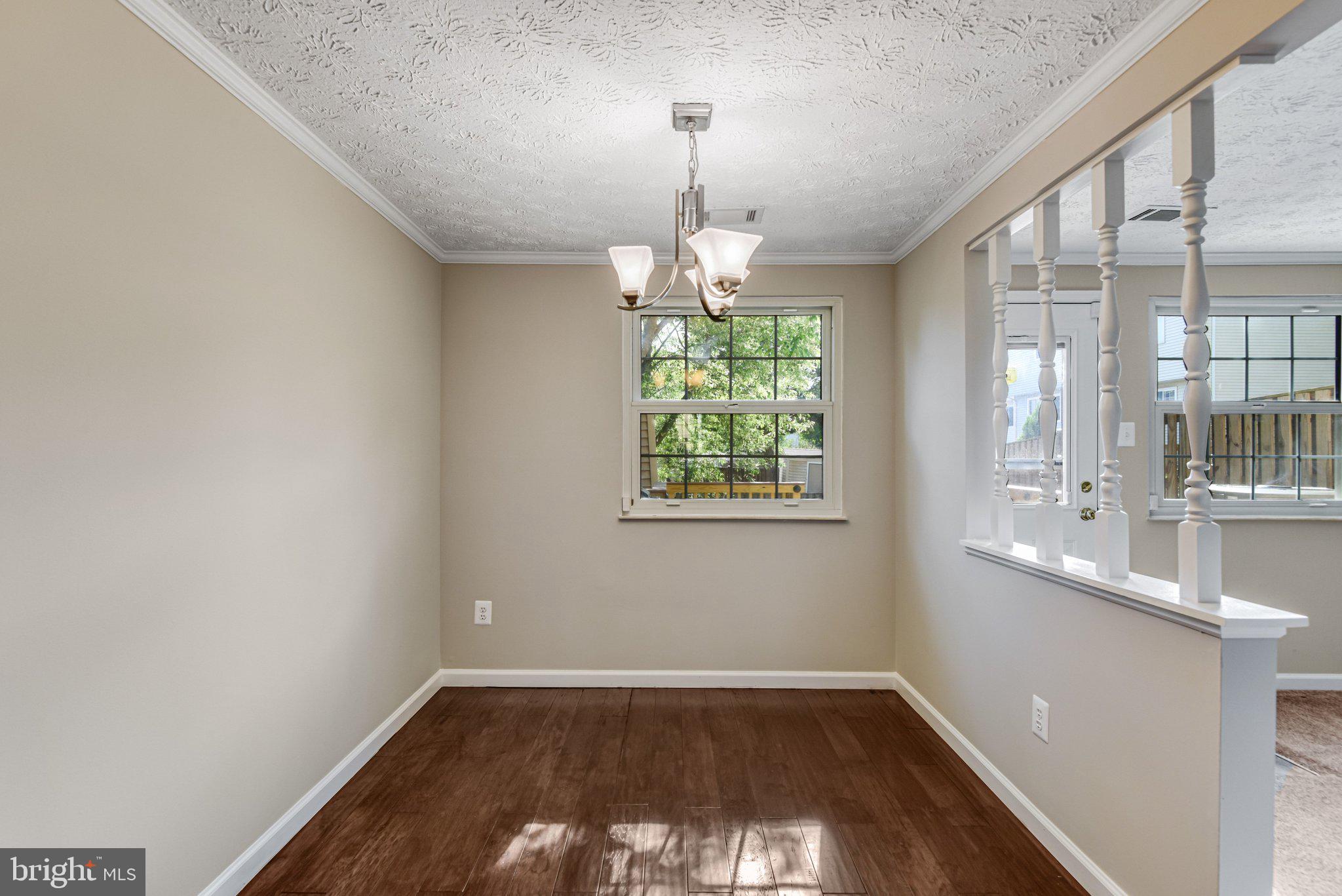 8339 Bark Tree Court Springfield, VA 22153 - Photo 10 of 23 an empty room with wooden floor and windows