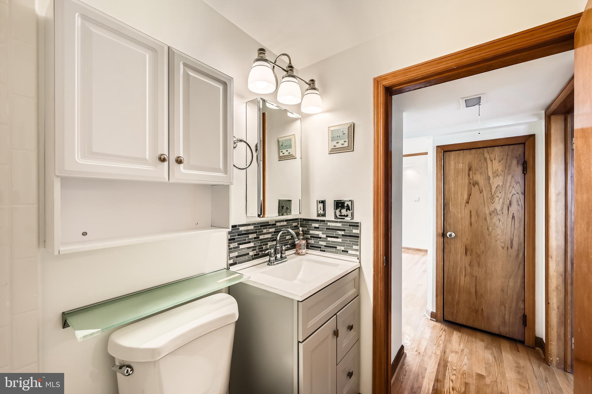 3169 Baybriar Road Baltimore, MD 21222 - Photo 13 of 28 a bathroom with a sink a toilet and mirror