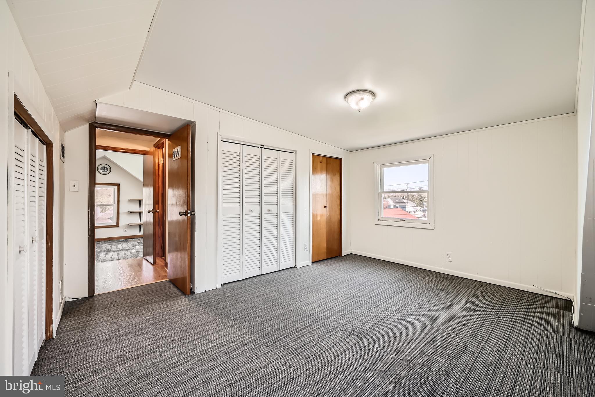 3169 Baybriar Road Baltimore, MD 21222 - Photo 17 of 28 an empty room with wooden floor and windows