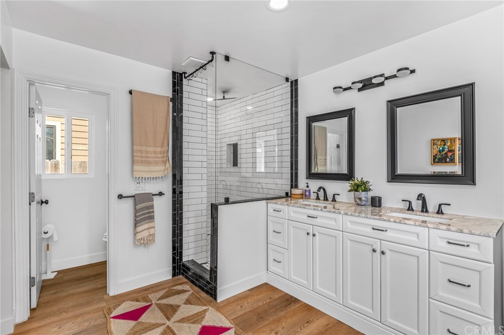 Undisclosed Address Costa Mesa, CA 92627 - Photo 9 of 15 a spacious bathroom with a double vanity sink a mirror a vanity and a bathtub