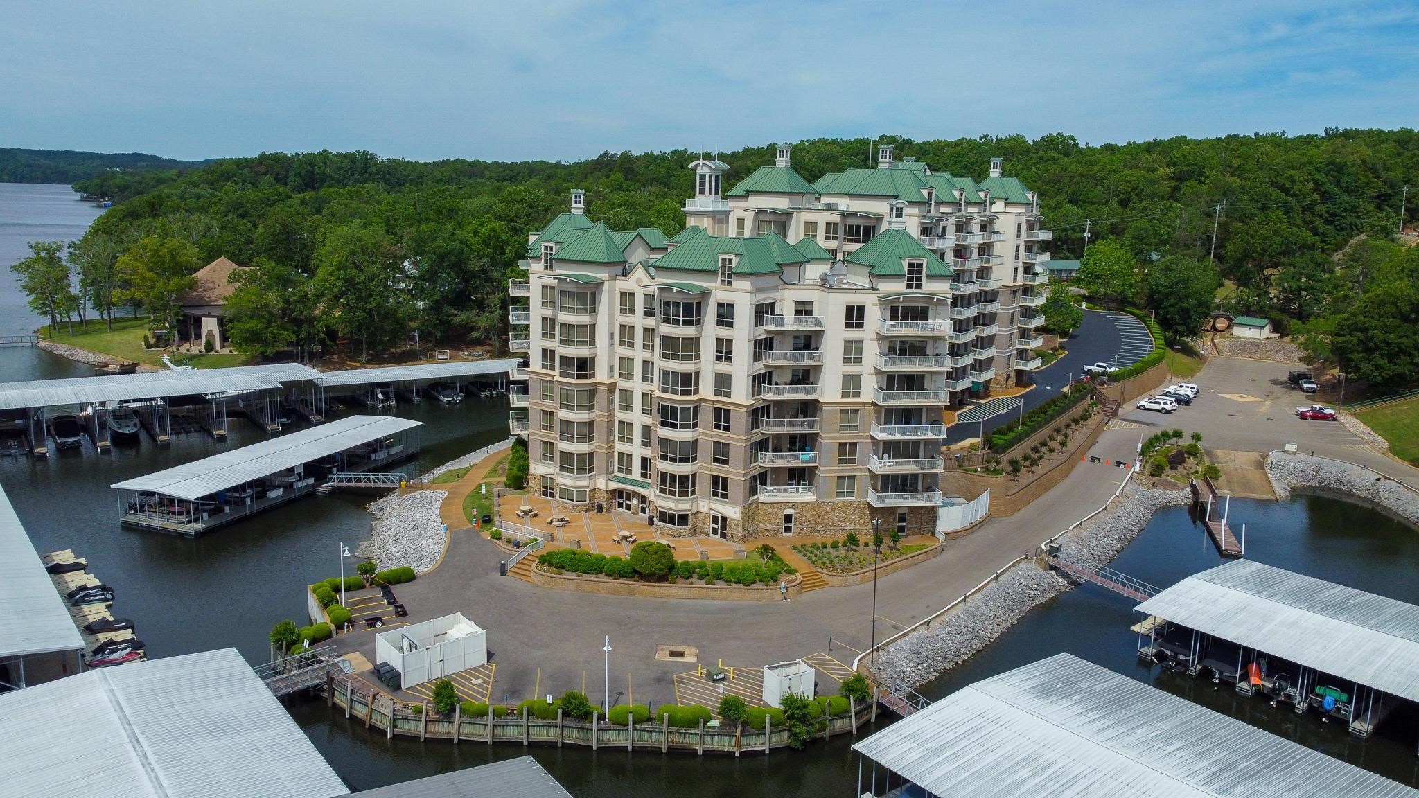 Multi-story residential building featuring green hip roofs and multiple private balconies