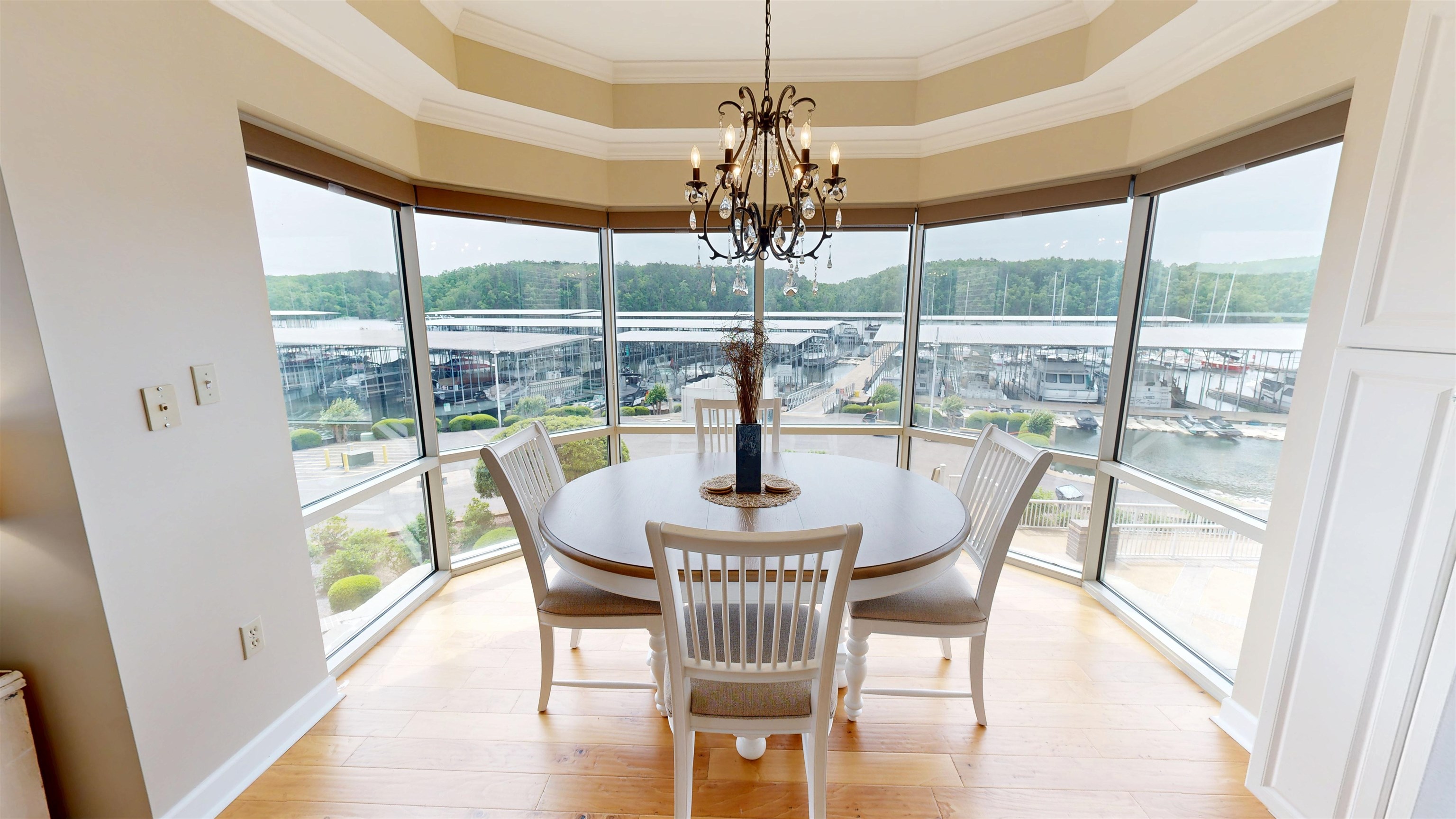 325 Cr 380 L-103 Road, Unit L103 Iuka, MS 38852 - Photo 16 of 40 Dining area featuring panoramic windows, hardwood flooring, an ornate chandelier, and built-in white cabinetry