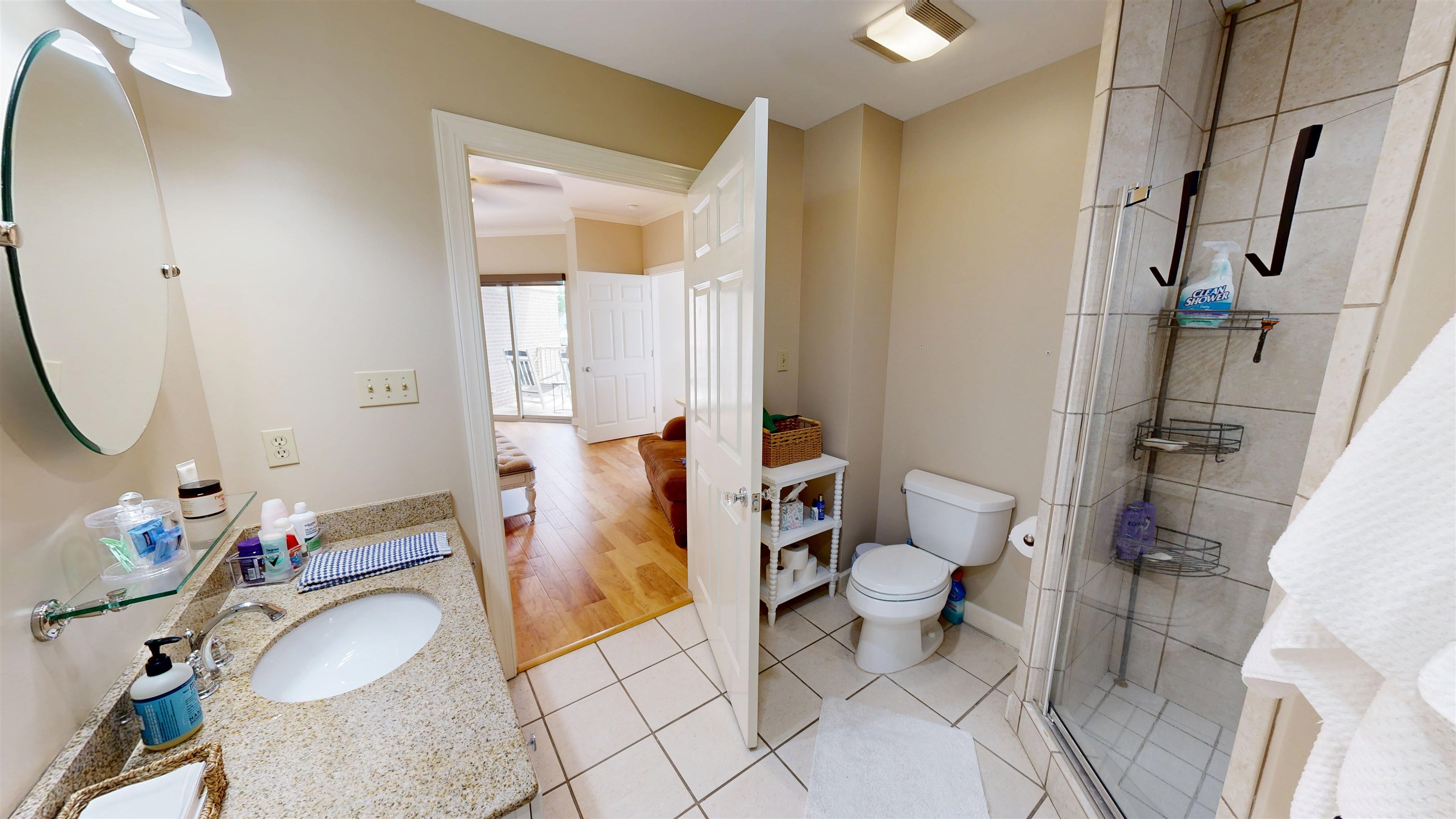 325 Cr 380 L-103 Road, Unit L103 Iuka, MS 38852 - Photo 22 of 40 Bathroom featuring a glass-enclosed shower with tiled surround, a vanity with a granite-style countertop and undermount sink, a wall-mounted oval mirror, and square tile flooring