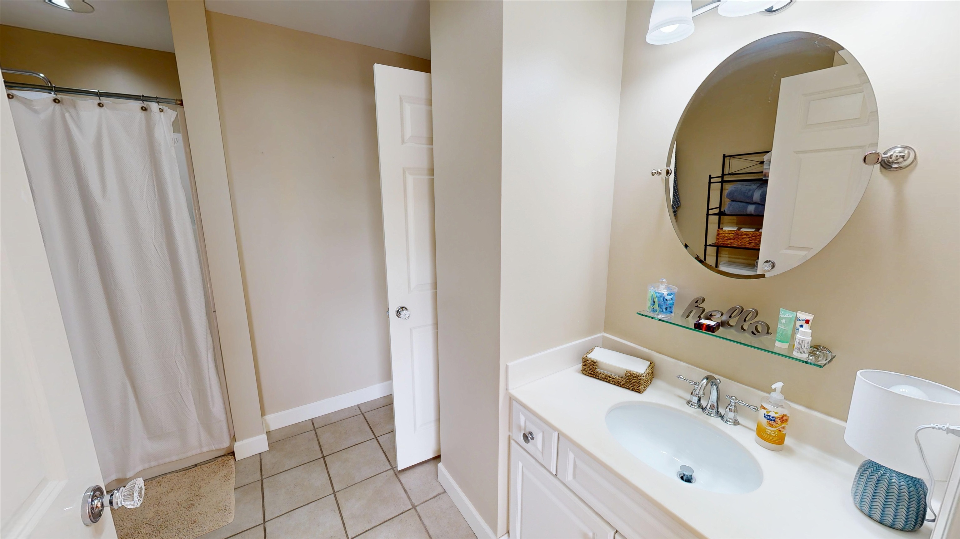 325 Cr 380 L-103 Road, Unit L103 Iuka, MS 38852 - Photo 28 of 40 Bathroom featuring a white vanity with an undermount sink, a large oval mirror, overhead light fixture, and tile flooring