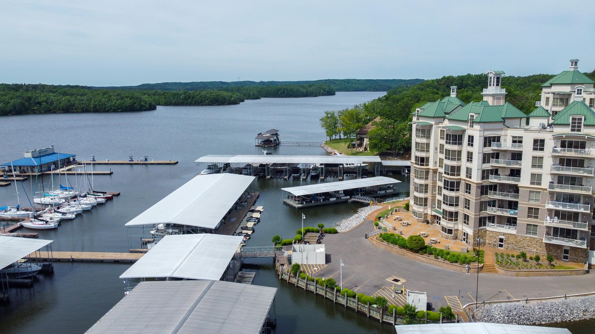 325 Cr 380 L-103 Road, Unit L103 Iuka, MS 38852 - Photo 35 of 40 Waterfront multi-story building featuring multiple private balconies, a terraced stone foundation, and a green roof