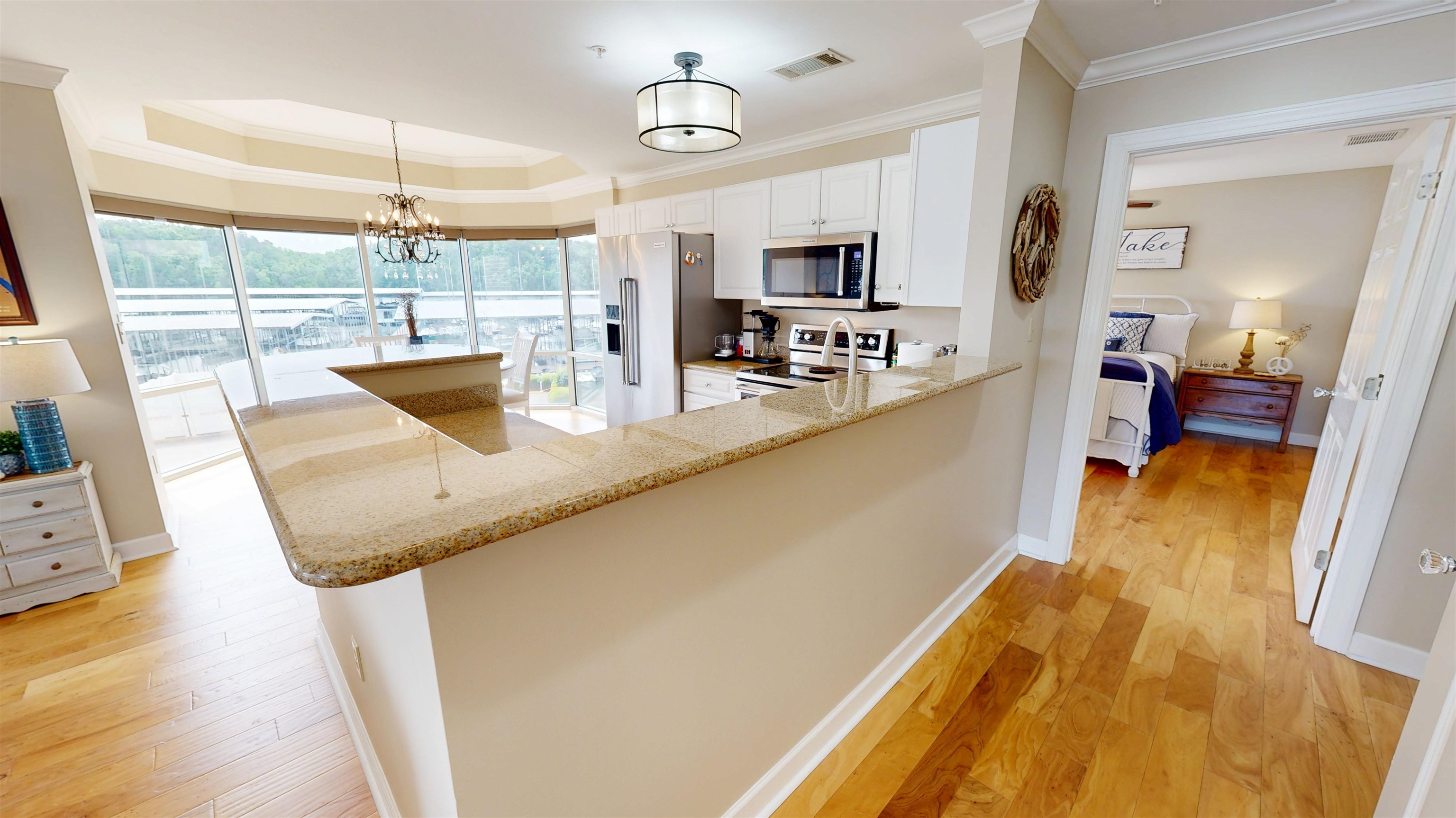 325 Cr 380 L-103 Road, Unit L103 Iuka, MS 38852 - Photo 7 of 40 Open-concept kitchen with granite countertops, white cabinetry, and stainless steel appliances