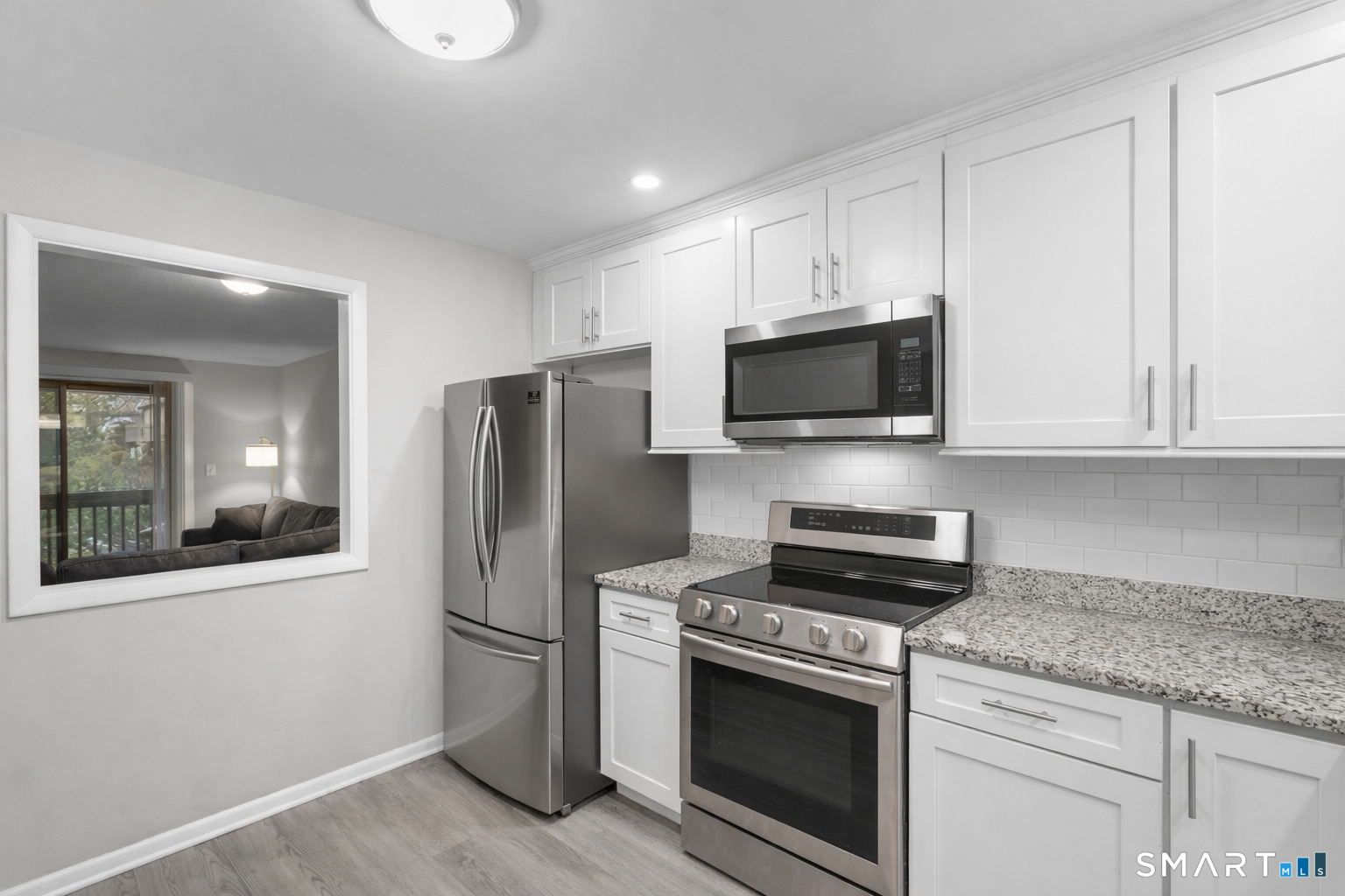 9 Avon Court, Unit 9 Beacon Falls, CT 06403 - Photo 2 of 11 a kitchen with stainless steel appliances granite countertop a refrigerator stove and microwave