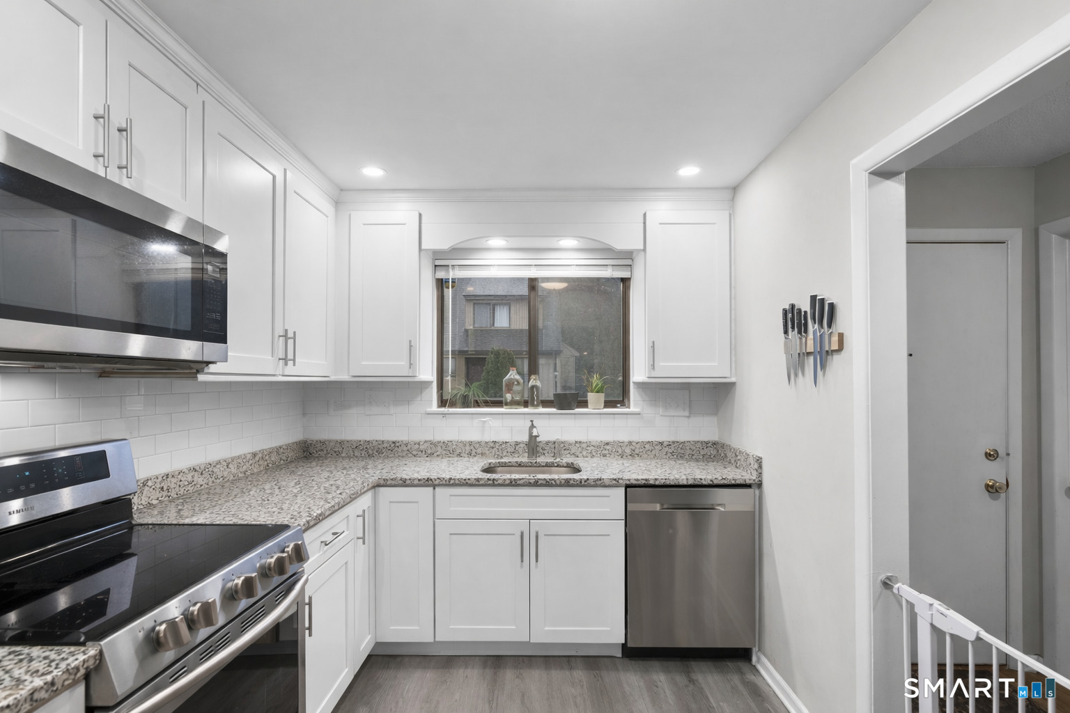 9 Avon Court, Unit 9 Beacon Falls, CT 06403 - Photo 3 of 11 a kitchen with stainless steel appliances granite countertop a sink and a stove