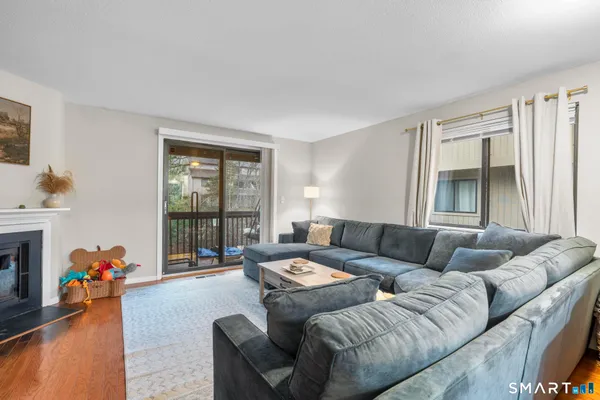 a living room with furniture and a floor to ceiling window