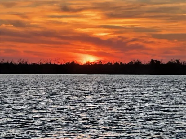 a front view of a house with potted plants