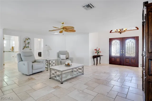 a living room with furniture and a chandelier