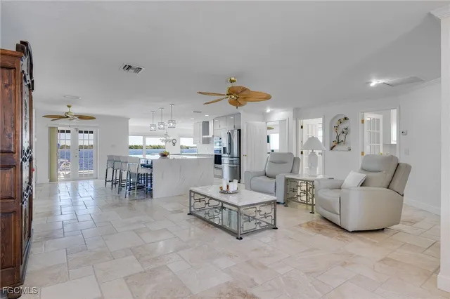 a living room with furniture and a kitchen