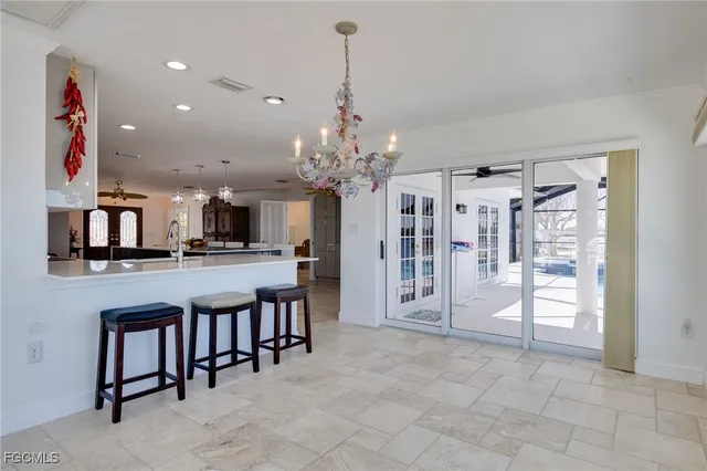 a view of a room with lots of wooden furniture and a chandelier
