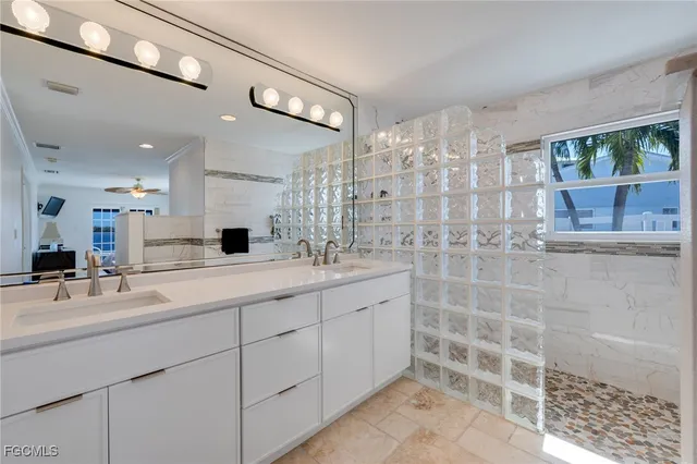 a bathroom with a double vanity sink a mirror and shower