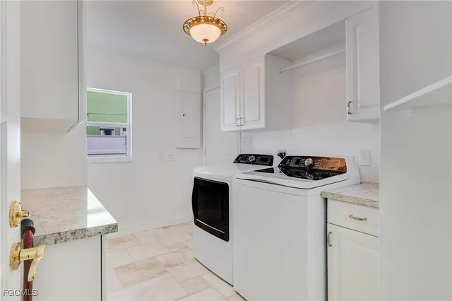 a white kitchen with stainless steel appliances