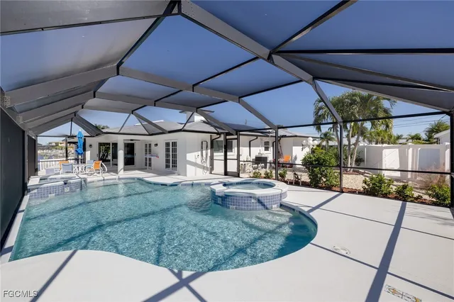 a view of a backyard with table and chairs under an umbrella