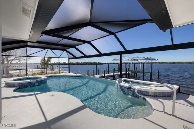 a view of a patio with table and chairs under an umbrella