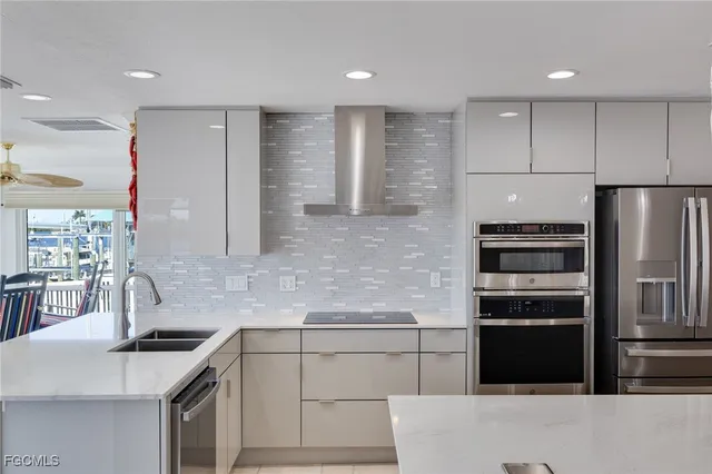 a kitchen with a sink stainless steel appliances and cabinets