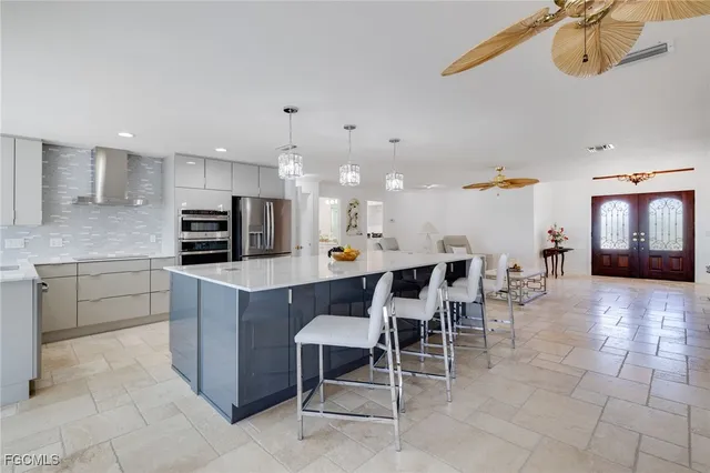 a large kitchen with a table and chairs in it
