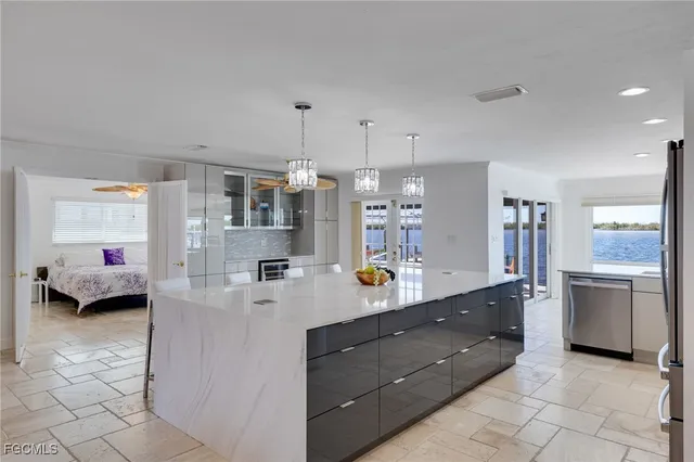 a kitchen with stainless steel appliances granite countertop a sink and cabinets