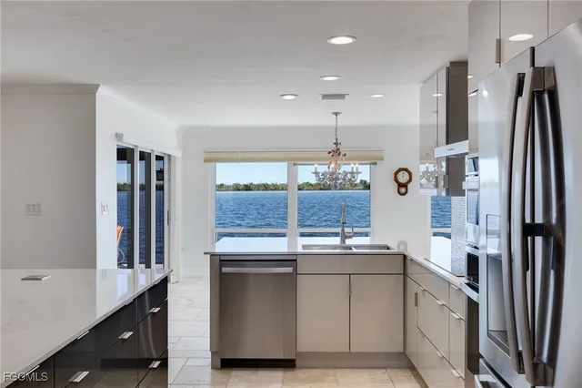 a kitchen with stainless steel appliances granite countertop a refrigerator and a sink