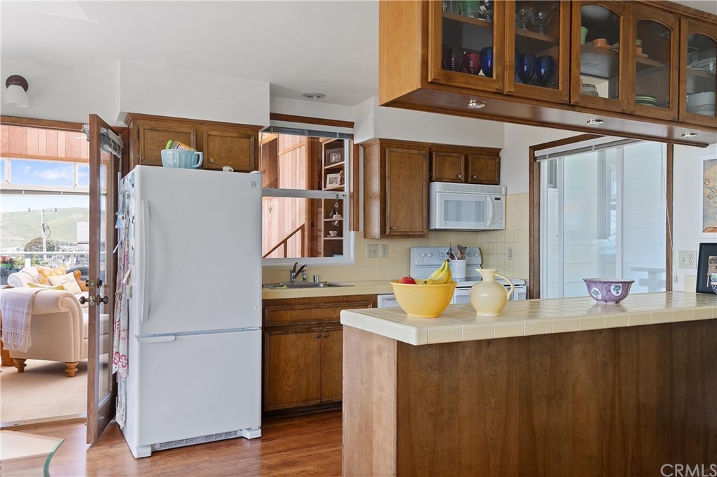 188 8th Street Cayucos, CA 93430 - Photo 15 of 33 a white refrigerator freezer sitting inside of a kitchen