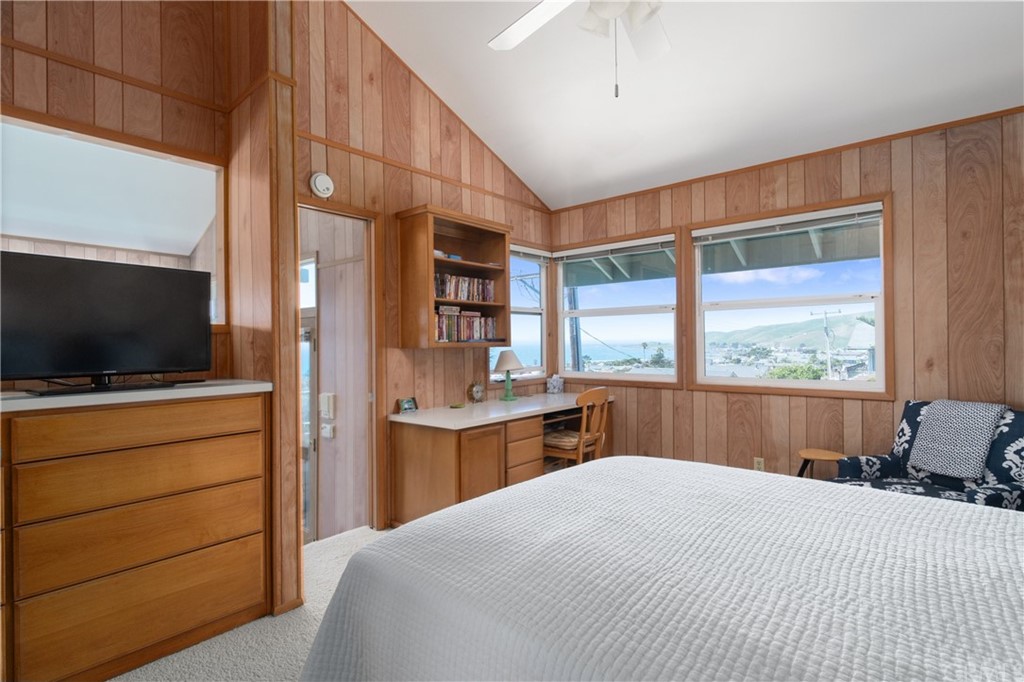 188 8th Street Cayucos, CA 93430 - Photo 19 of 33 a bedroom with a large bed and a flat tv screen on dresser