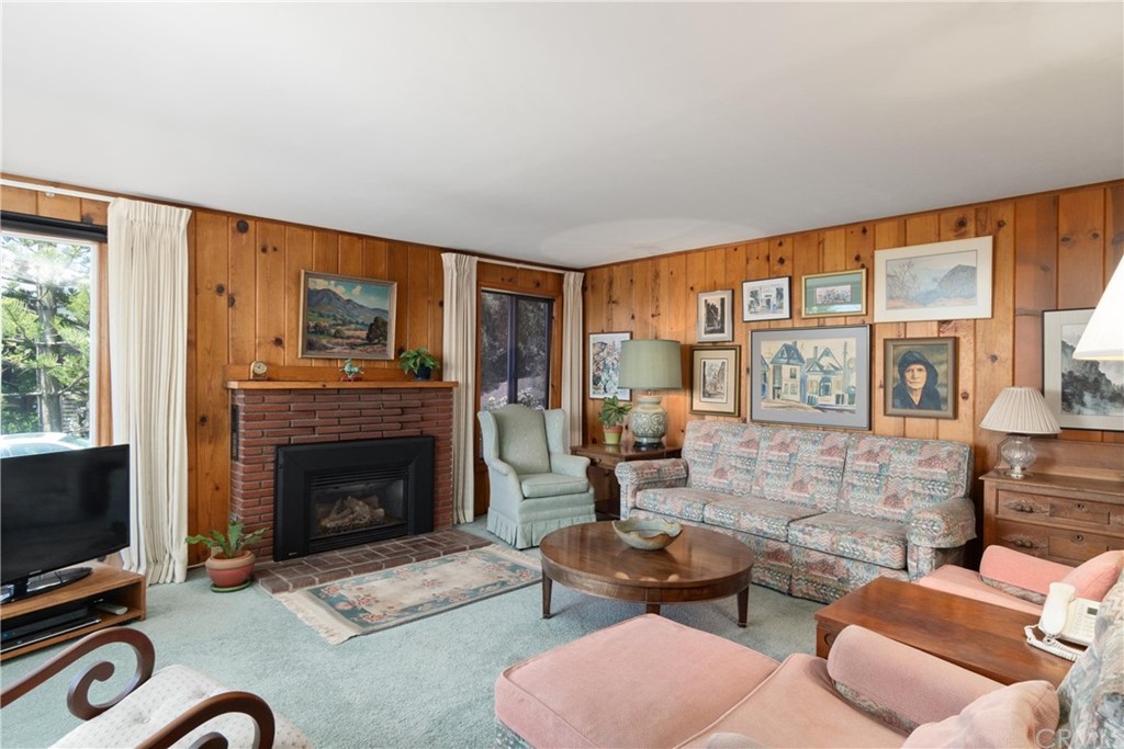 188 8th Street Cayucos, CA 93430 - Photo 3 of 33 a living room with furniture a flat screen tv and a fireplace