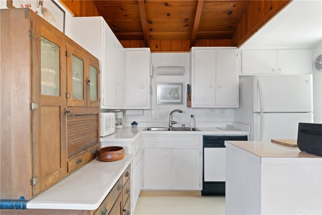 188 8th Street Cayucos, CA 93430 - Photo 5 of 33 a kitchen with a sink a stove and refrigerator