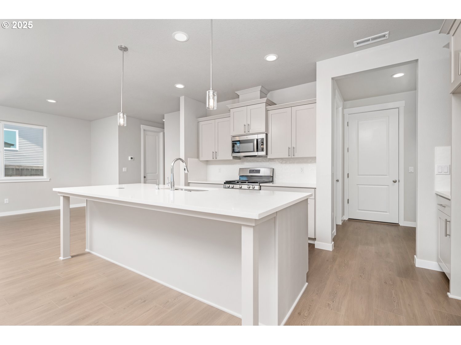 8900 South 1st Street, Unit 17 Ridgefield, WA 98642 - Photo 3 of 19 a kitchen with kitchen island a sink stainless steel appliances and cabinets